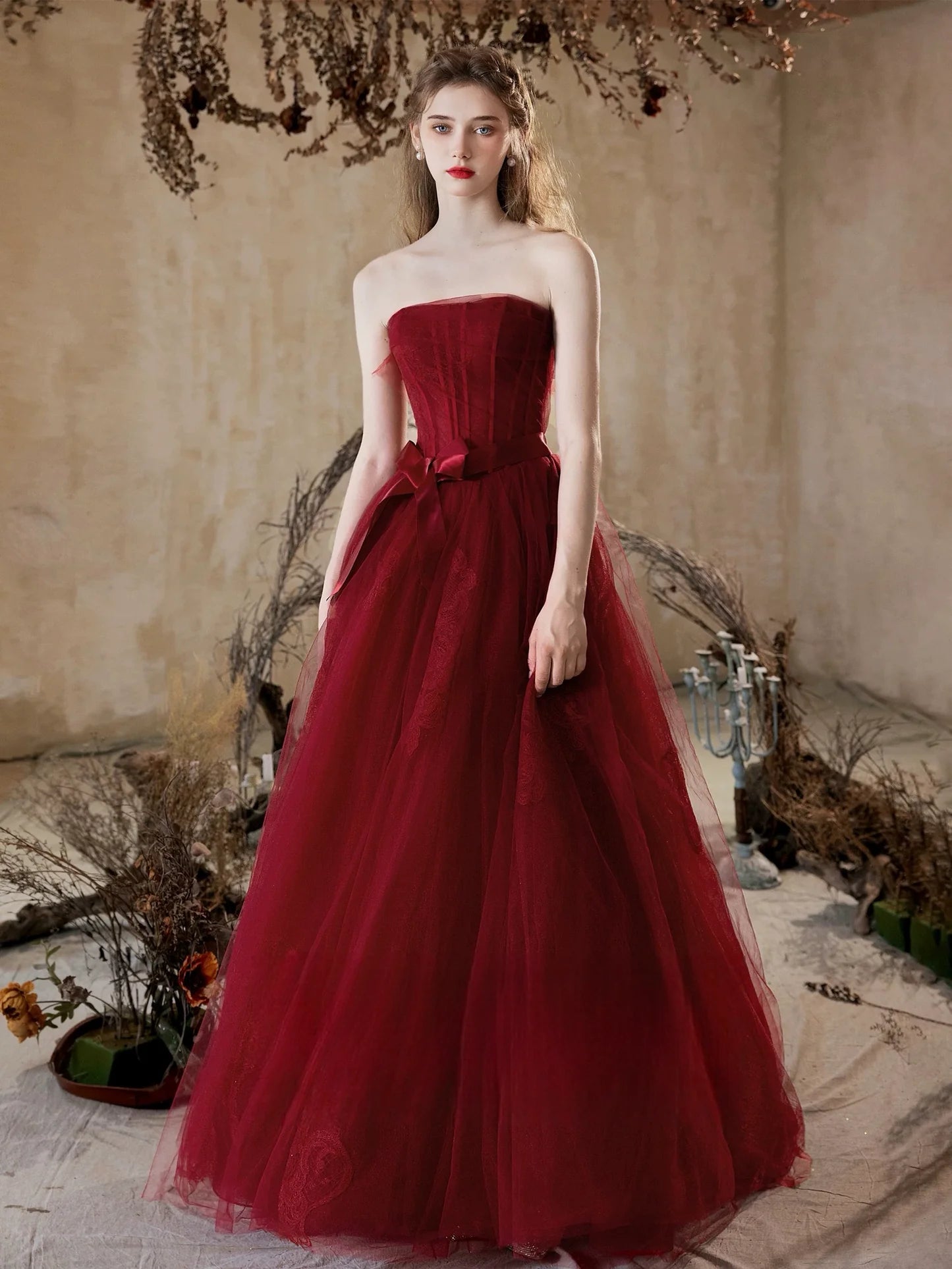 Back view of the burgundy A-line dress, highlighting lace bodice and long skirt.