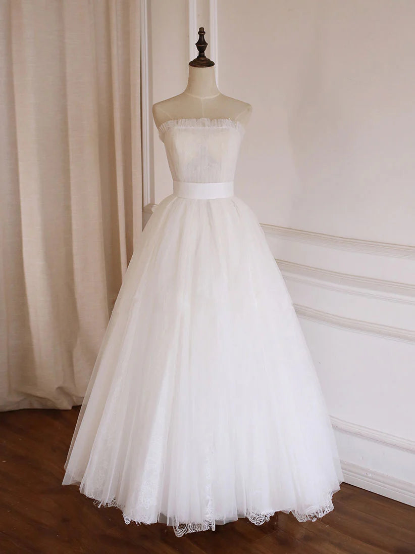Full view of an elegant white A-line tulle lace long prom dress.