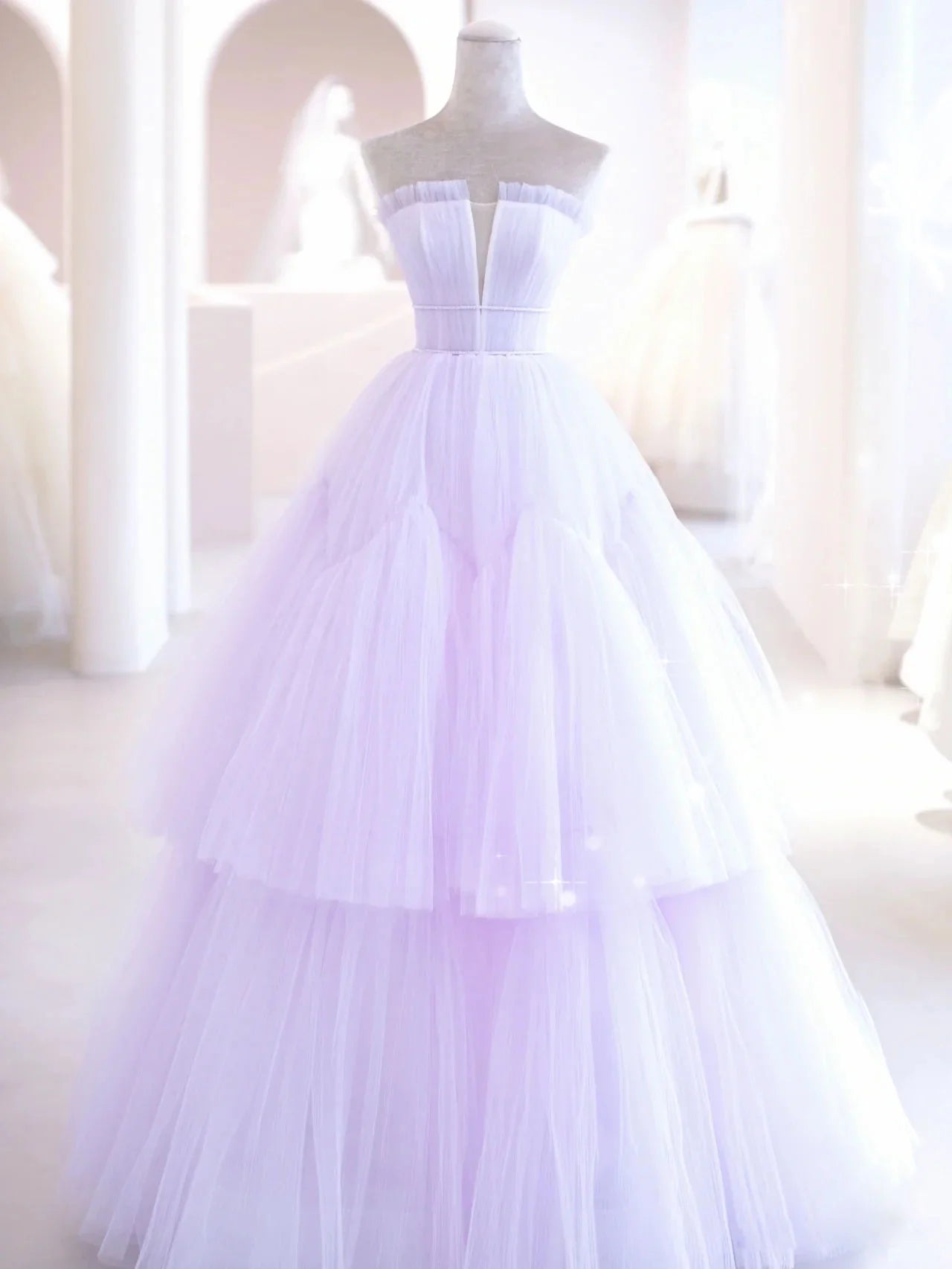 Close-up of the elegant purple tulle long dress with a fitted waist.