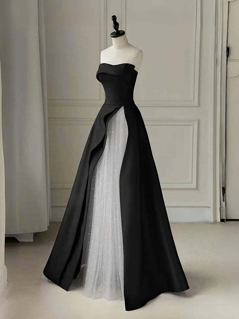 Model wearing an elegant A-line tulle and satin long prom dress in black and white.