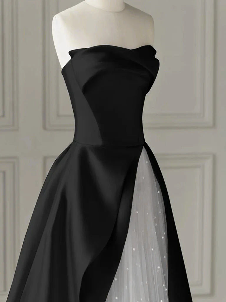 Side view of a model in the black and white A-line formal gown.