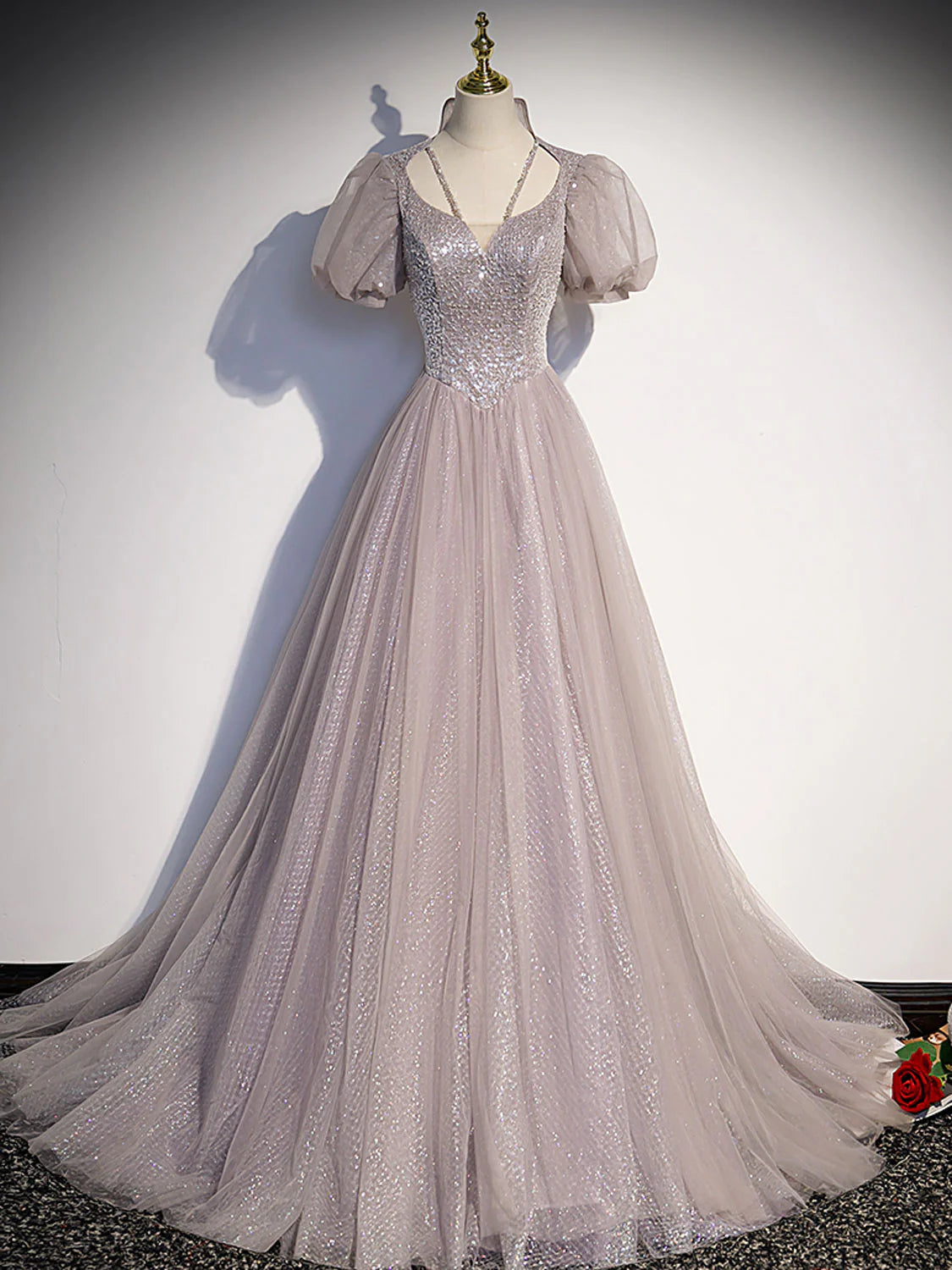 Model wearing an elegant light pink A-line tulle sequin long prom dress, front view.