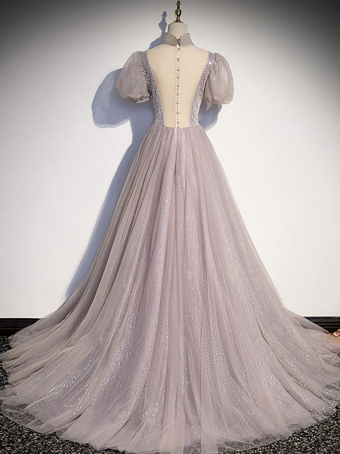 Model wearing an elegant light pink A-line tulle sequin long prom dress, side view, showcasing the sequin details.