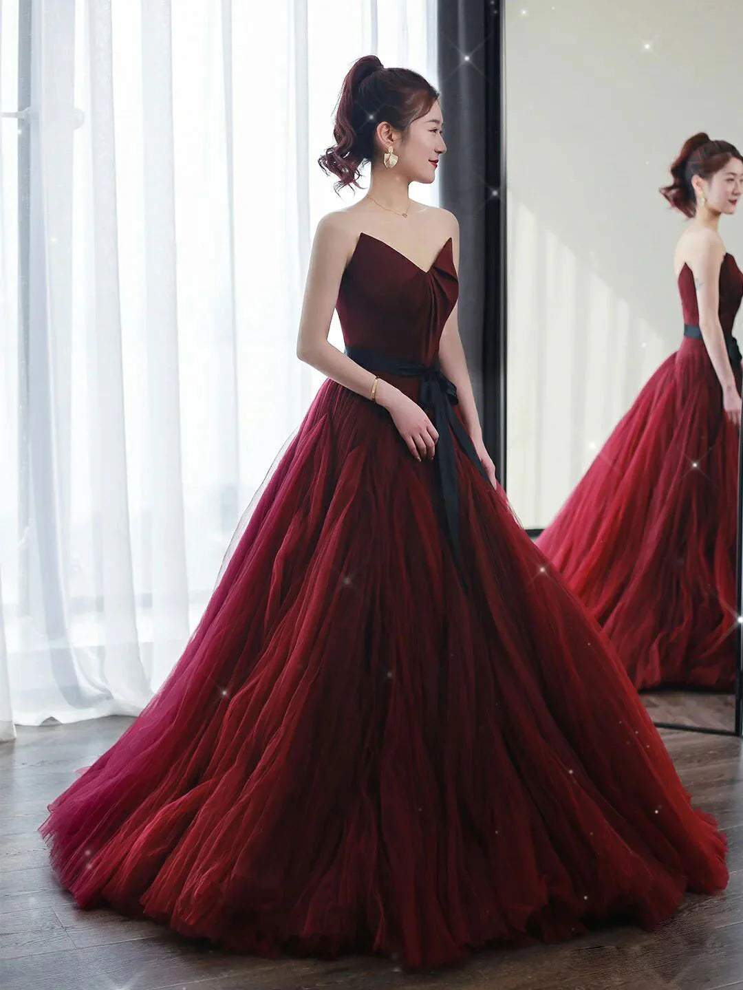Back view of an A-line burgundy tulle evening gown.
