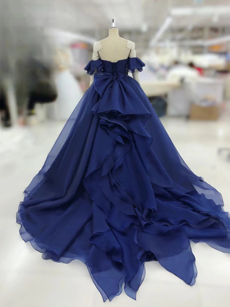 Back view of a dark blue A-line tulle long formal dress.