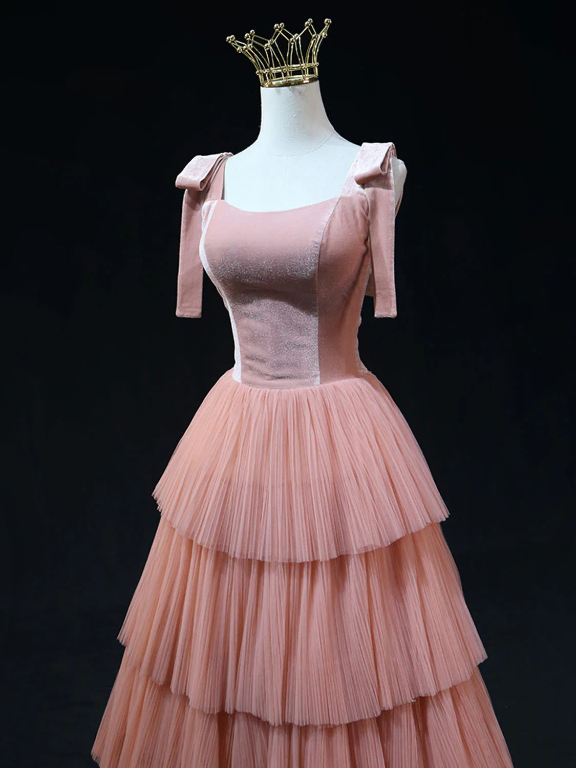 Side view of a flowing A-line pink tulle formal dress.