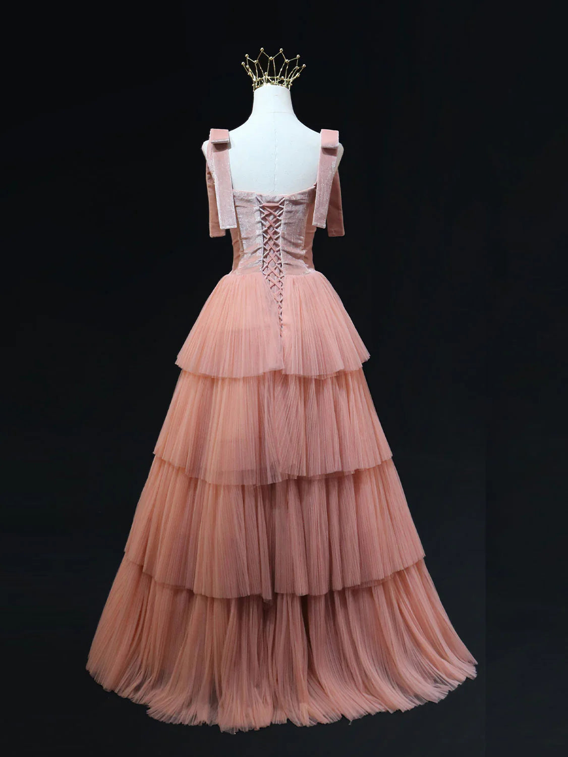 Back view of a pink tulle long evening gown.