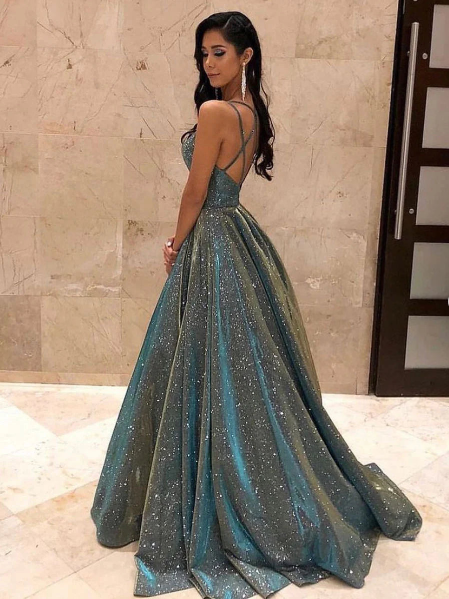 Back view of a woman in a gray A-line backless long prom dress with spaghetti straps.