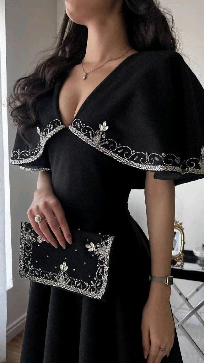 Full length view of a woman wearing a black A-line formal evening gown.