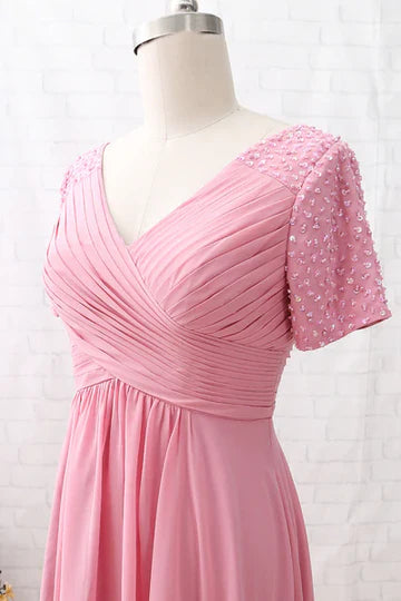 Side profile of the pink chiffon mother of the bride dress, showcasing its flowing A-line silhouette.