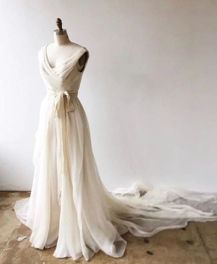 Model showcasing an ivory V-neck chiffon evening gown with a flowing A-line skirt.