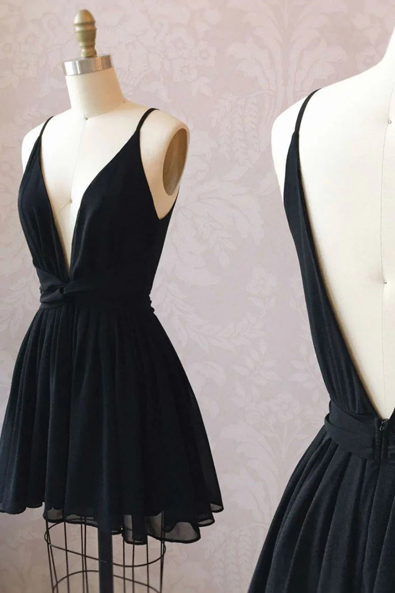 Woman wearing an elegant black V-neck chiffon short prom dress.