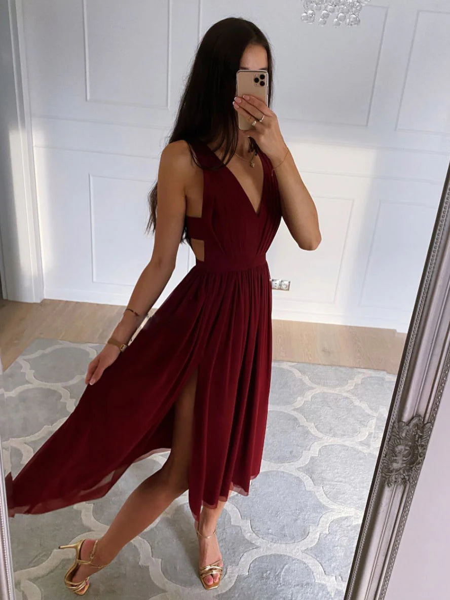 Woman wearing an elegant burgundy V-neck high-low chiffon prom dress.