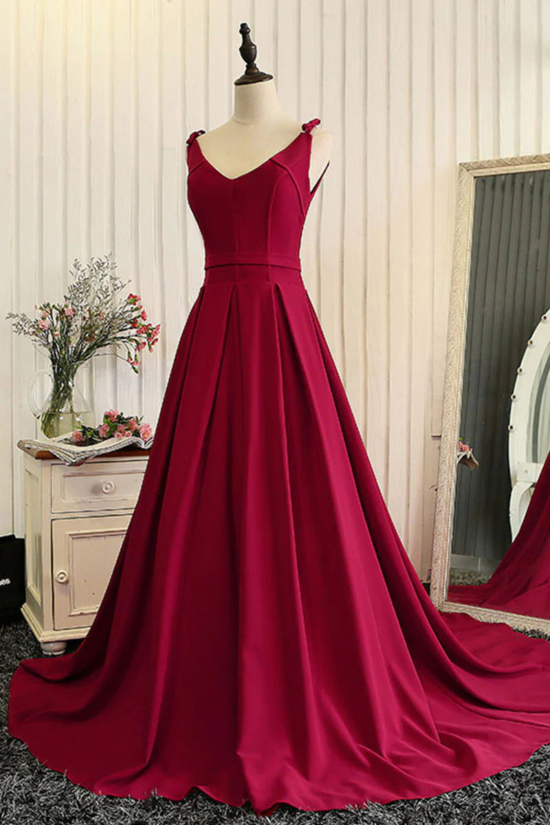Model in a red V-neck satin evening gown, side view.