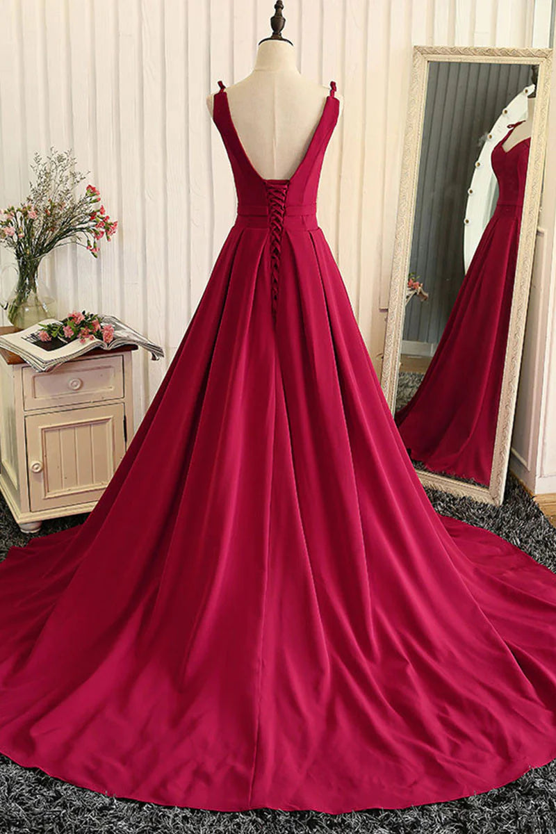 Back view of a model wearing a red A-line satin formal dress.