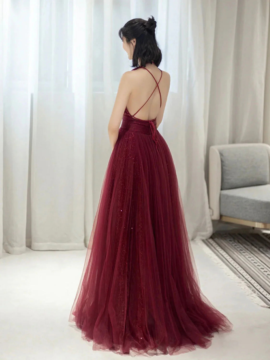 Side view of the elegant burgundy sequin tulle evening gown.