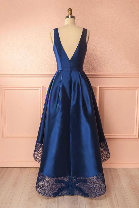 Close-up of the dark blue V-neck high-low dress on a model.