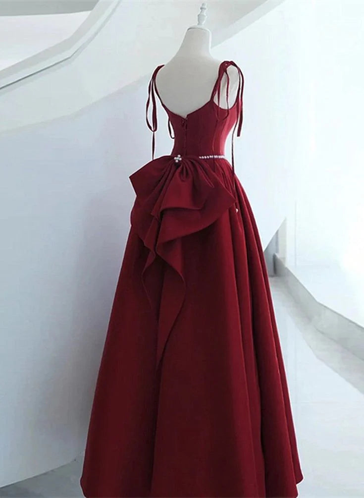 Back view of a model wearing a wine red satin long formal dress, showcasing the lace-up detail.