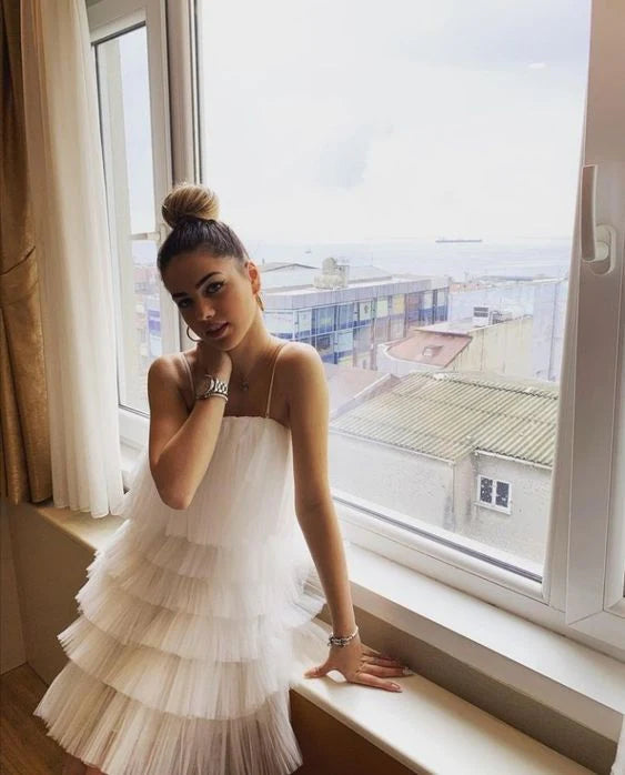 Model wearing an elegant A-line V-neck multi-layer chiffon white short homecoming dress.