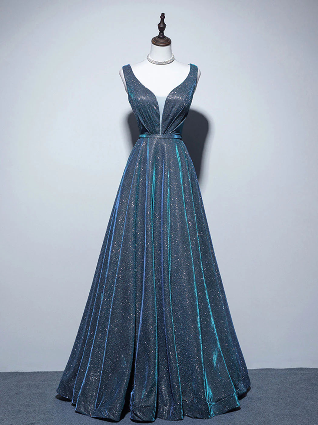 Elegant A-line V-neck satin blue long prom dress with a flowing skirt.