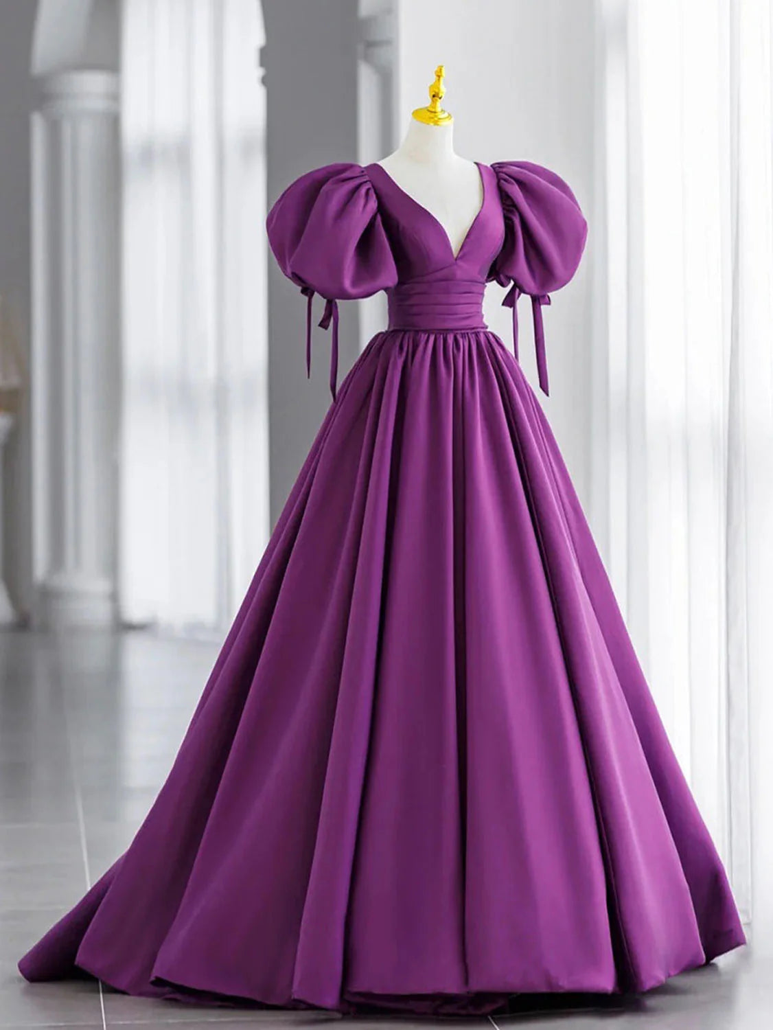 Model wearing an elegant purple V-neck satin long prom dress, side view.