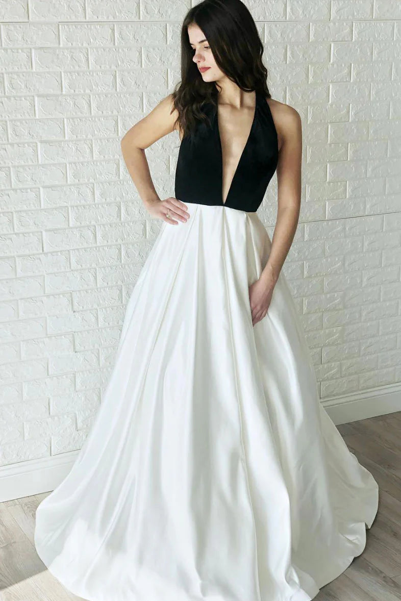 Front view of a woman wearing an elegant white V-neck satin long prom dress.
