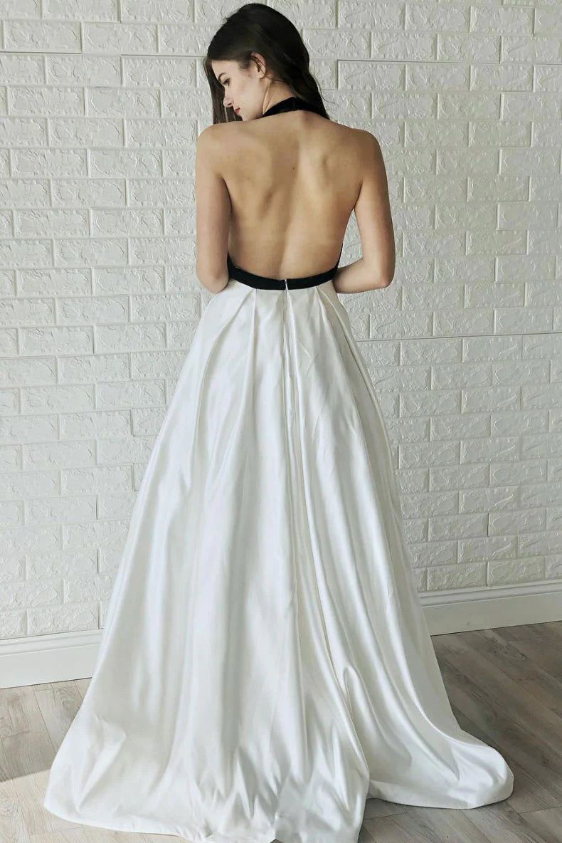 Side view of a woman in a white V-neck satin long prom dress, showcasing the flowing A-line skirt.