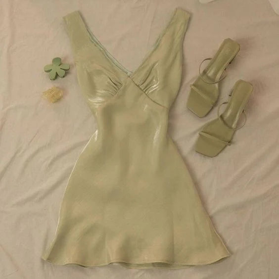 Model wearing an elegant green satin A-line V-neck midi dress.