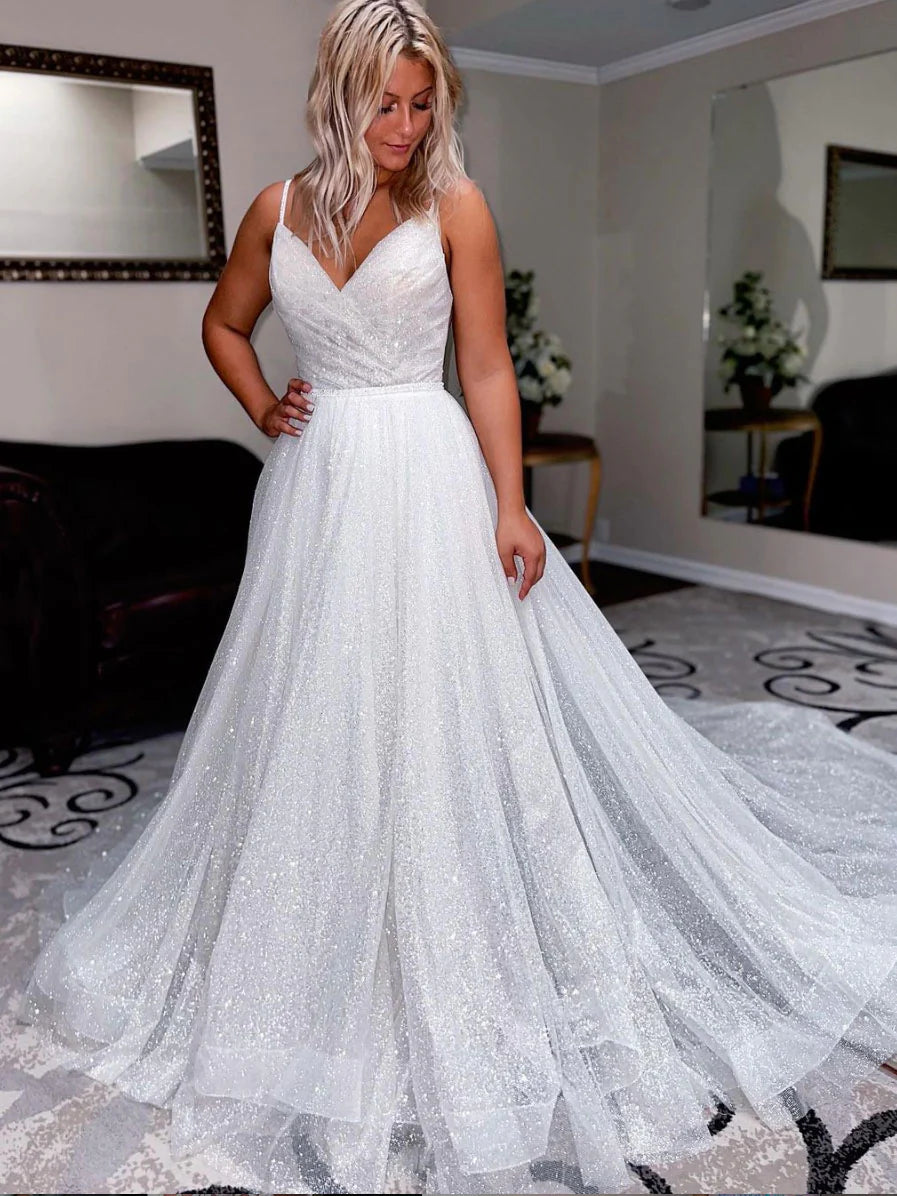 Elegant woman in a white V-neck sequin tulle long prom dress.