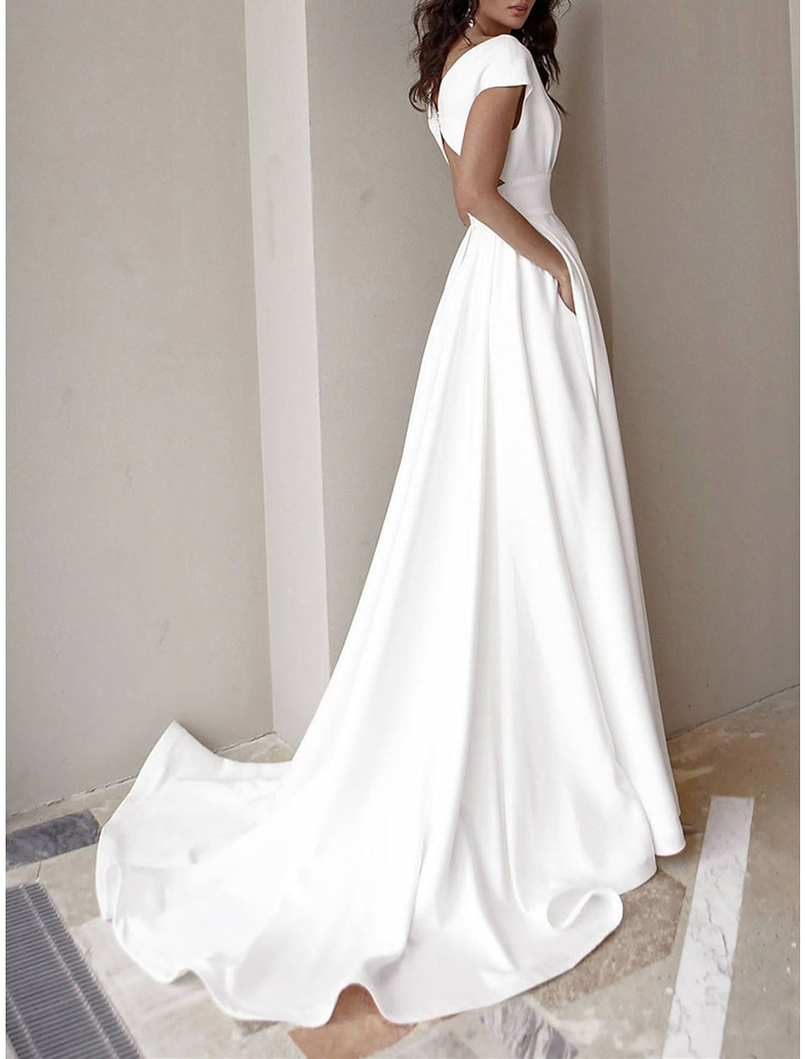 Elegant white V-neck short sleeve prom dress with ruffle pockets.