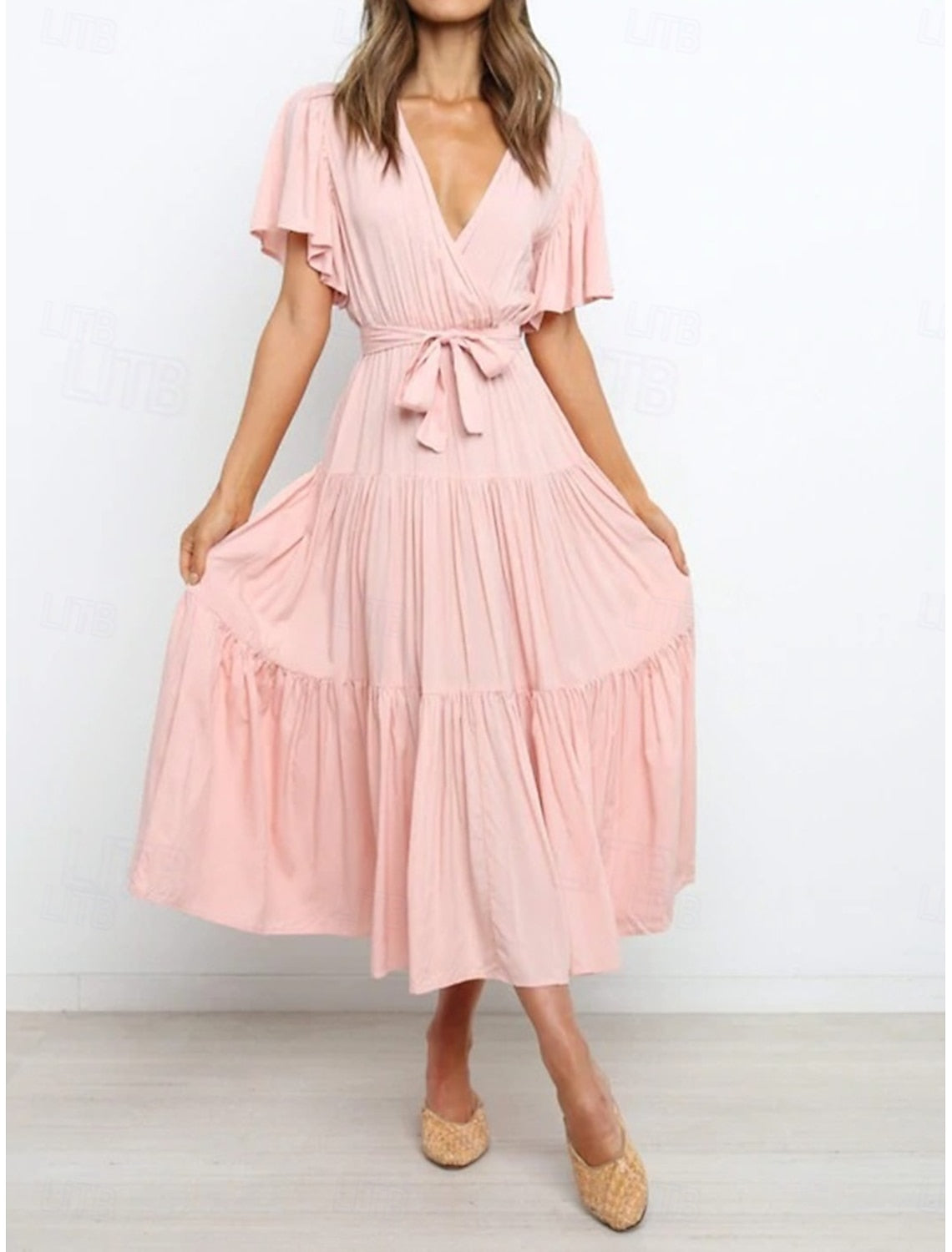 Woman wearing an elegant solid A-line V-neck short sleeve maxi dress, front view.