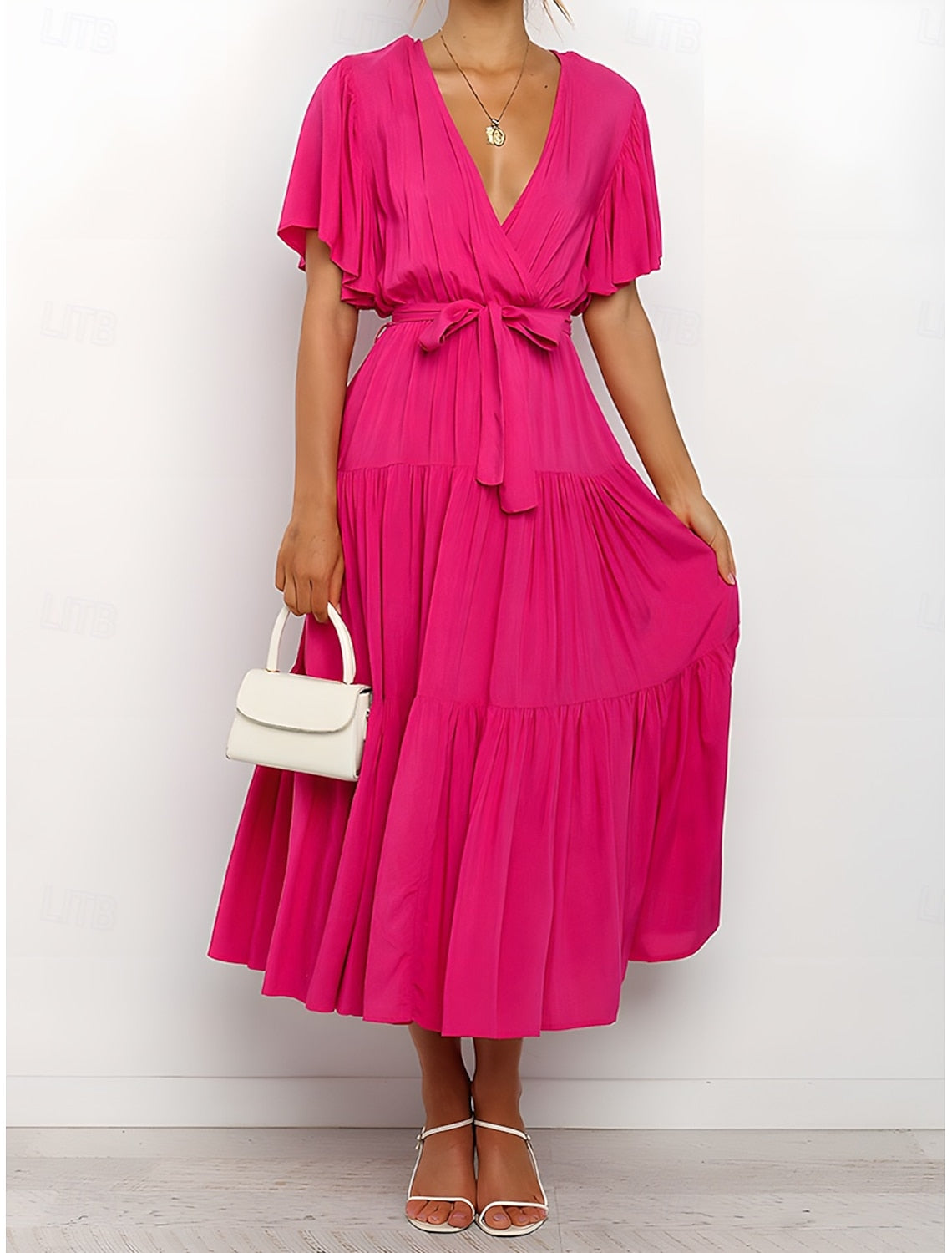 Woman wearing an elegant solid A-line V-neck short sleeve maxi dress, side view.