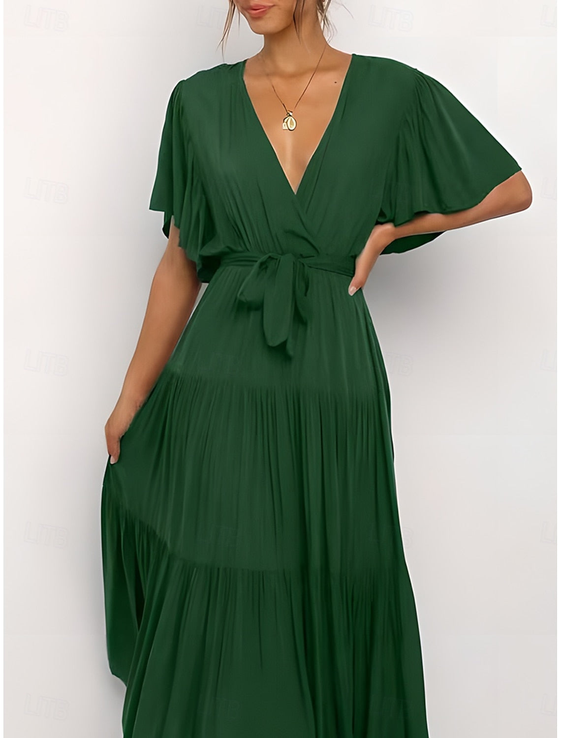 Woman posing in an elegant solid A-line V-neck short sleeve maxi dress.