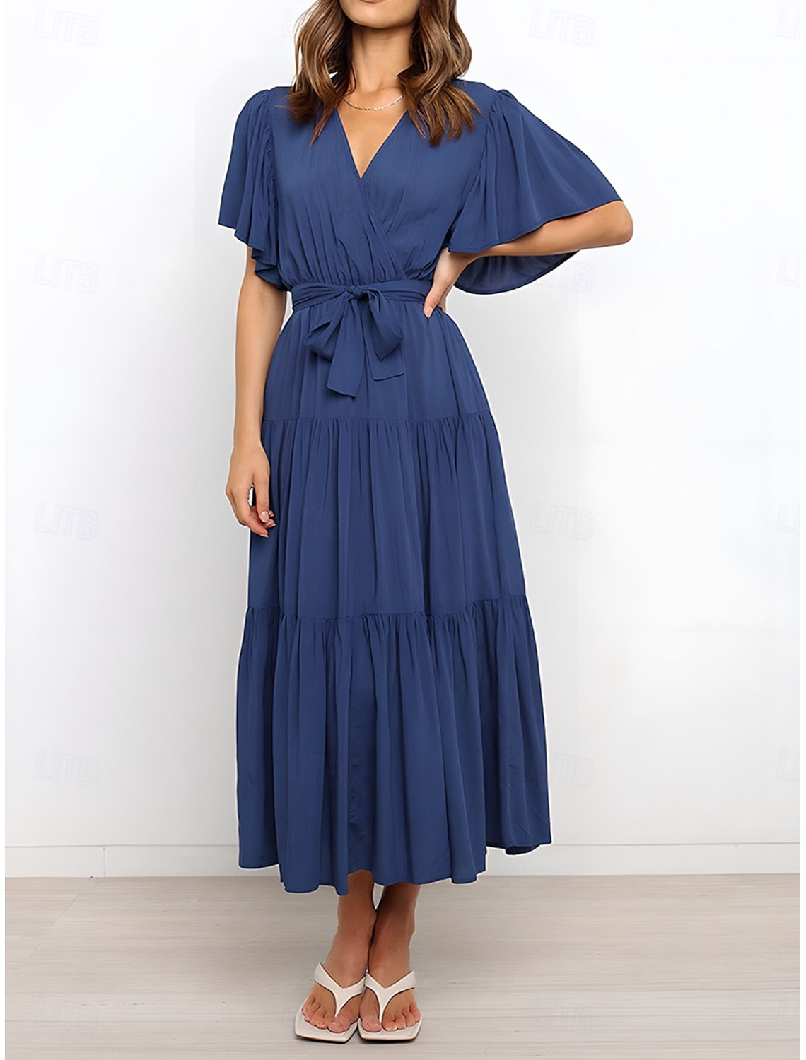 Woman walking in an elegant solid A-line V-neck short sleeve maxi dress.