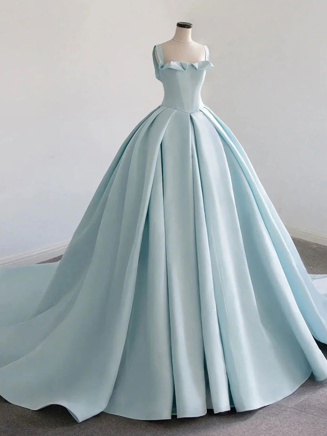 Elegant blue satin long prom dress with V-neck and sweep train, front view.