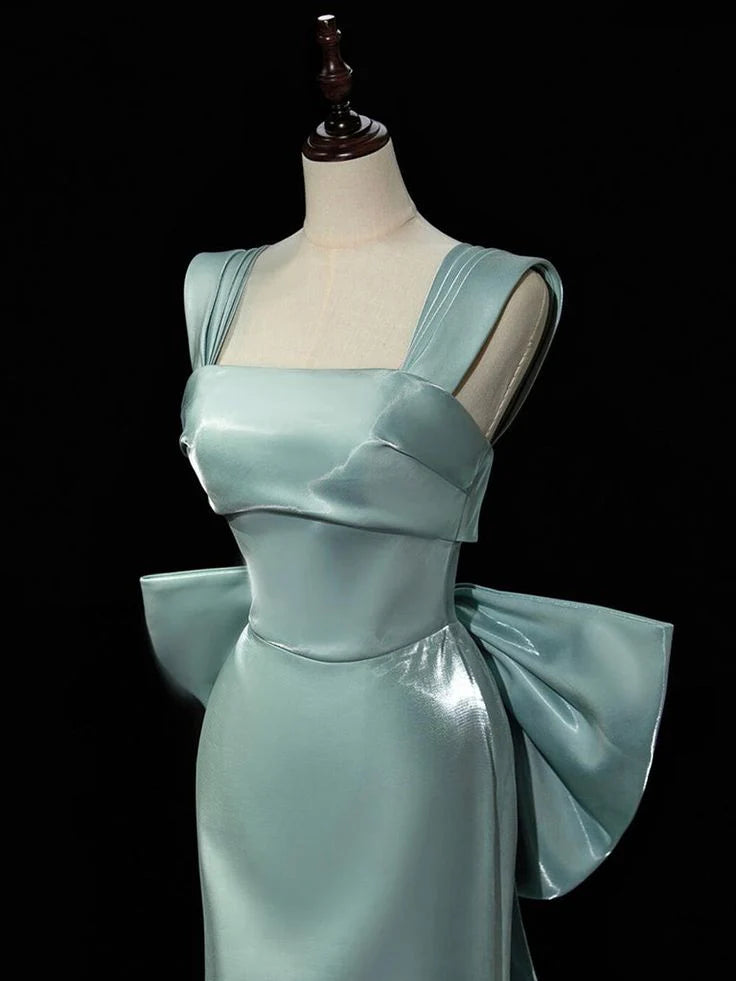Side view of the flowing green satin formal gown.