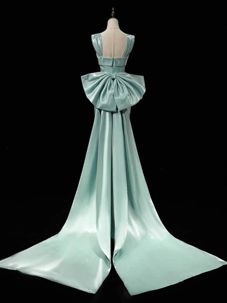 Back view of the green satin dress, showcasing the elegant bow tie.