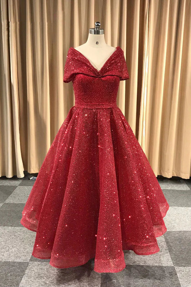 Woman wearing an elegant burgundy V-neck tea length prom dress.