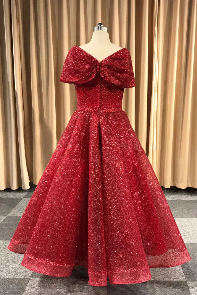 Side view of a woman in a burgundy V-neck A-line evening dress.
