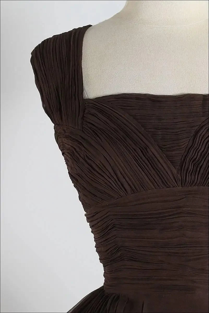Back view of a dark brown short chiffon retro cocktail dress.