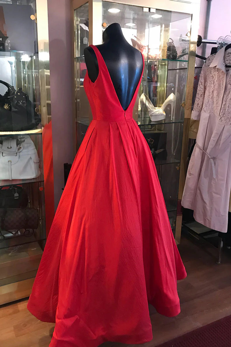Full view of a red A-line tea-length evening dress with a flowing skirt.