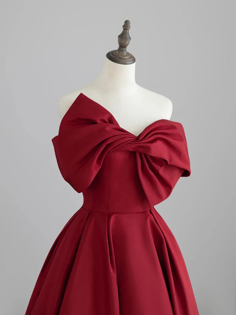Side view of a dark red A-line satin formal dress.