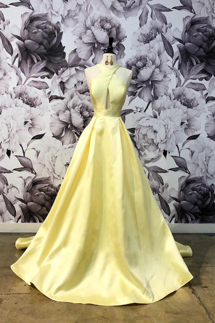 Woman wearing an elegant yellow satin V-neck A-line long prom dress.