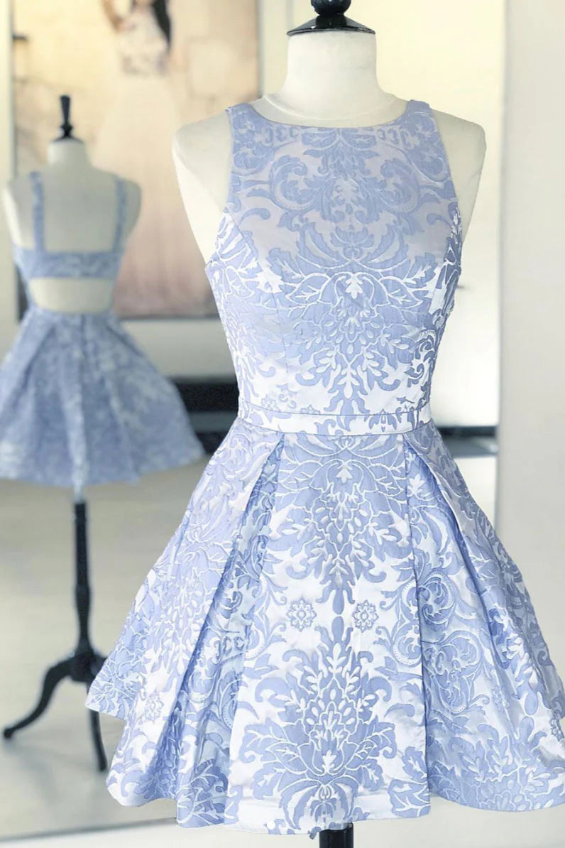 Model wearing a blue lace short A-line prom or homecoming dress.
