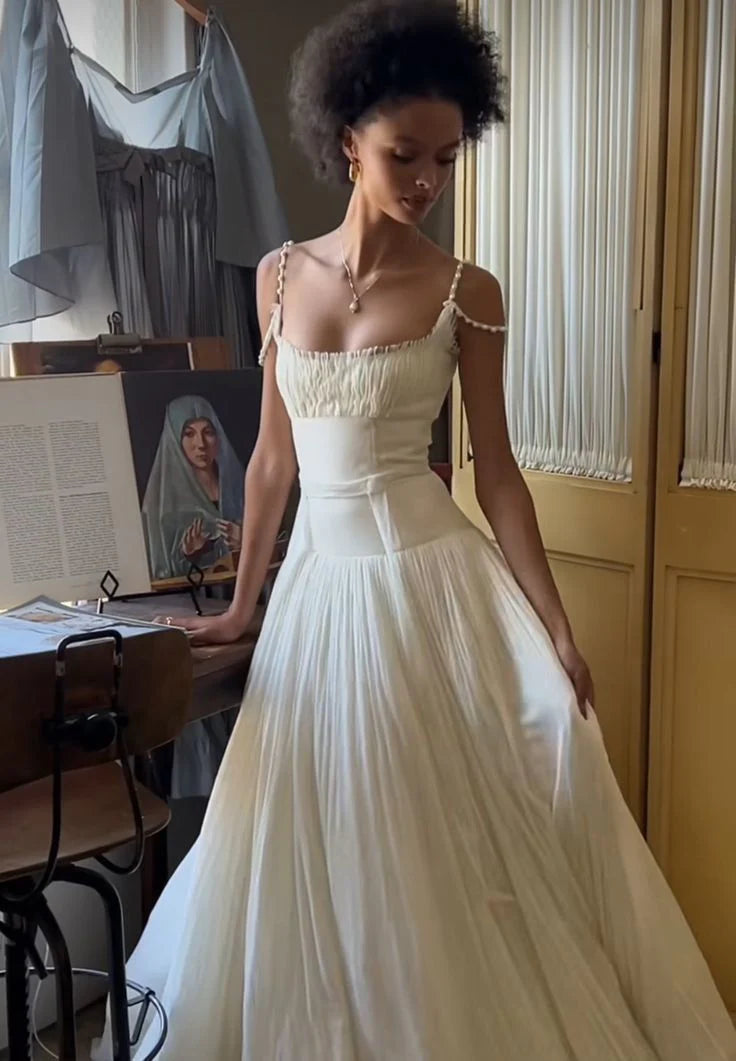Woman wearing an elegant A-line V-neck long white wedding dress.