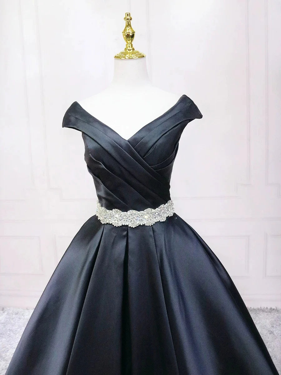 Back view of a woman in a black A-line V-neck satin evening gown.