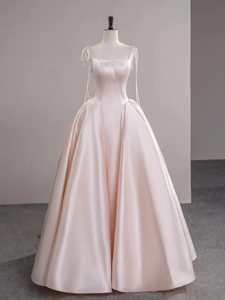 Model wearing an elegant A-line satin champagne pink long prom dress.