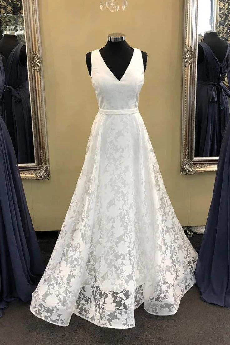 Elegant woman wearing a white V-neck satin and lace long prom dress.