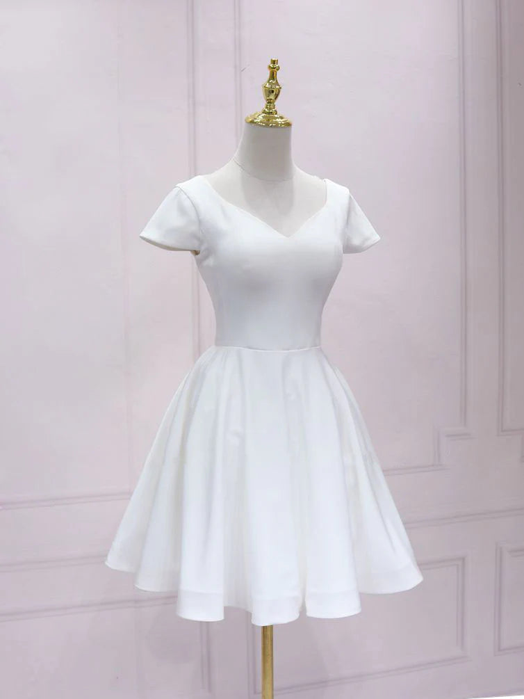 Woman wearing a white V-neck satin lace short prom dress.