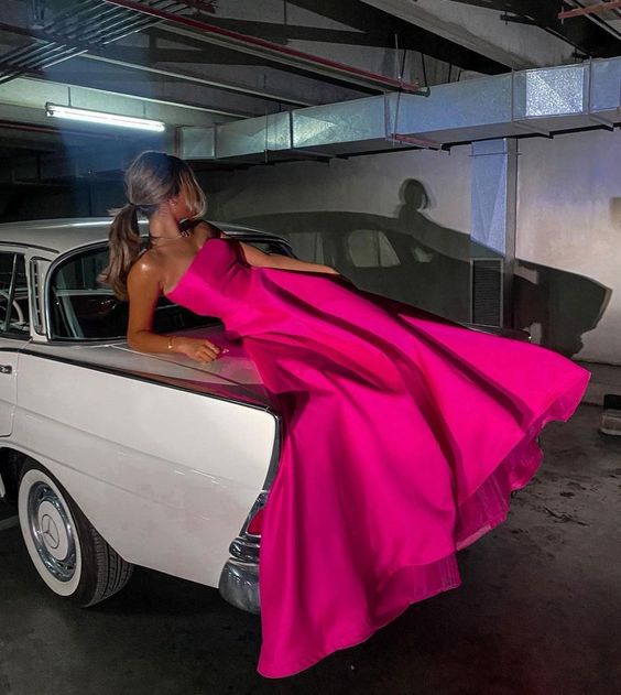 Elegant pink satin sleeveless prom dress with a flowing skirt.